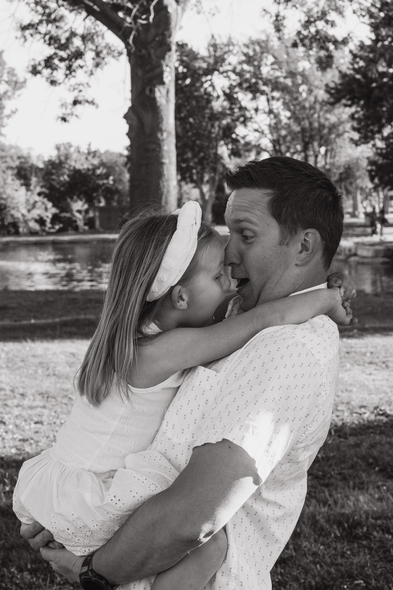Omaha family photography — dad holding his daughter as she laughs