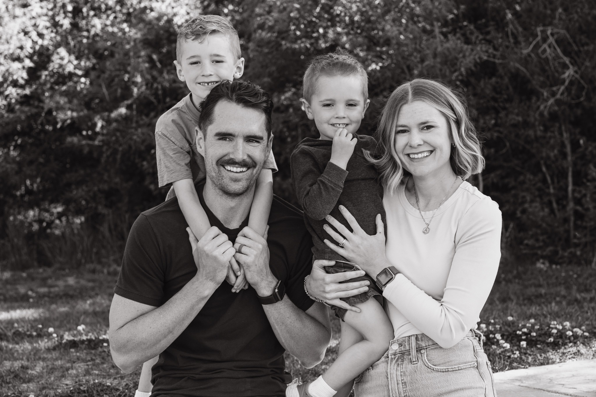 Omaha family portrait — parents and two young boys laughing together
